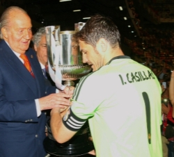 Don Juan Carlos hace entrega al capitán del Real Madrid, C.F., Iker Casillas, de la Copa de S.M. el Rey de Fútbol, como ganadores de la edición 2013/1